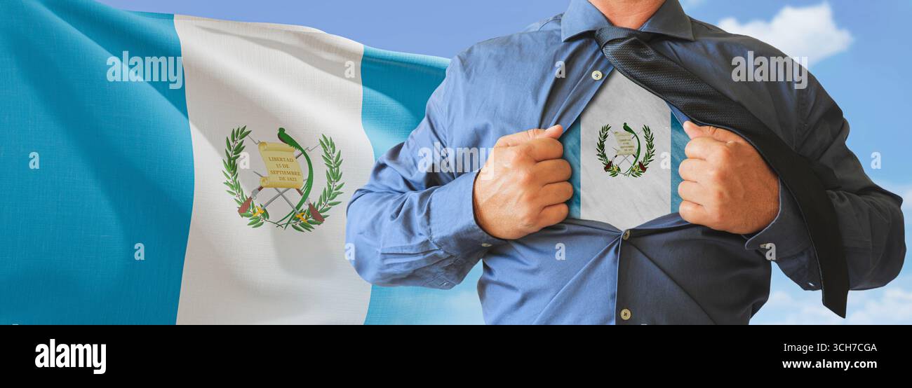 A businessman opening his shirt like super hero with Guatemala flag and shows how patriotic he is by revealing his countries flag beneath printed on a Stock Photo