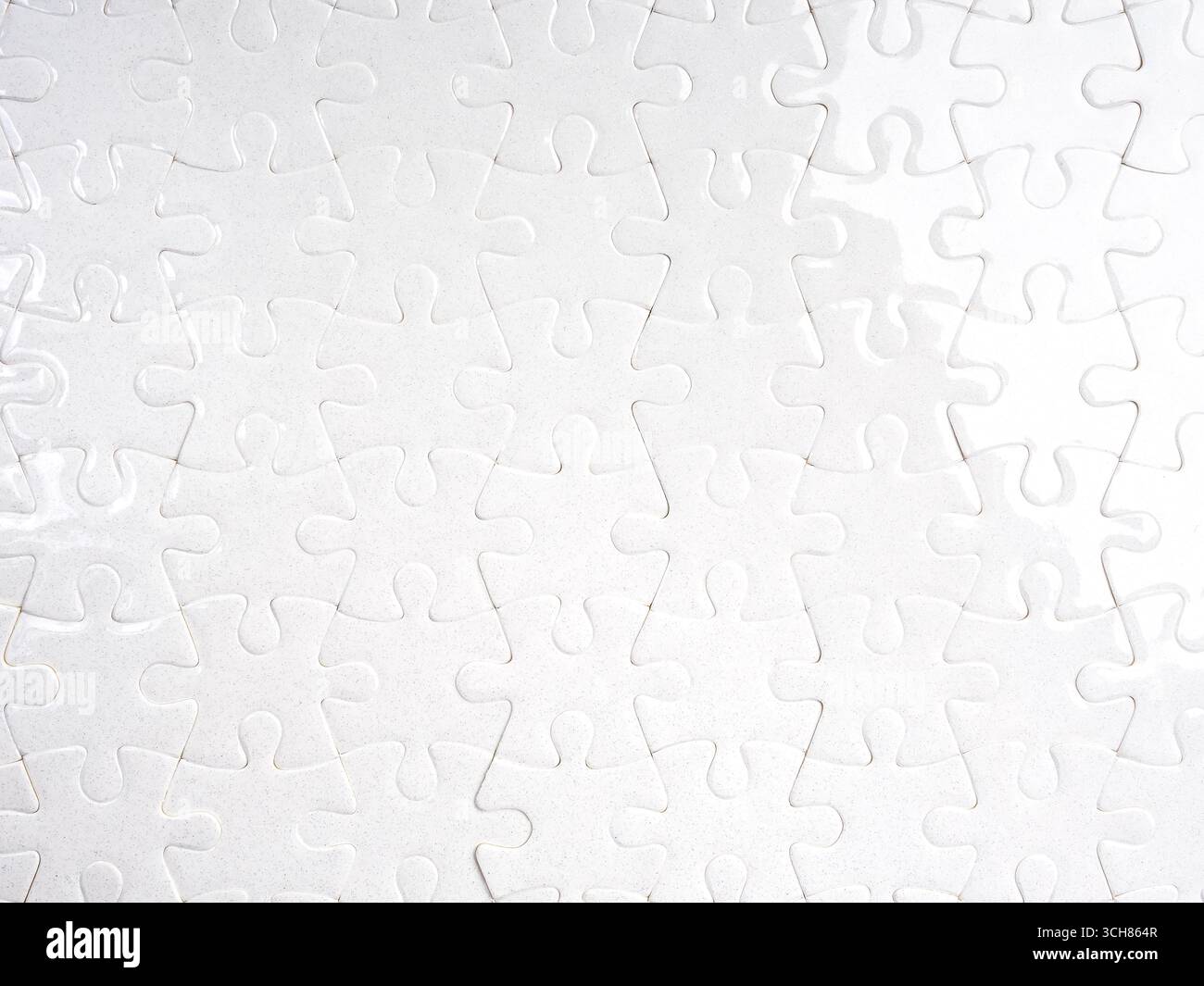 White jigsaw puzzle fully assembled with clean minimal look, representing completion, teamwork, integration, problem-solving, unity, and system connec Stock Photo