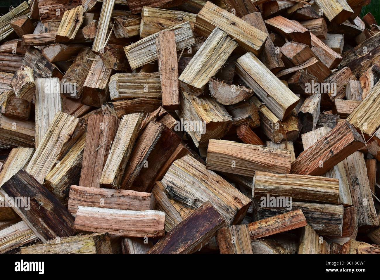 Pile of split log firewood fuel ready for burning in a wood heater ...