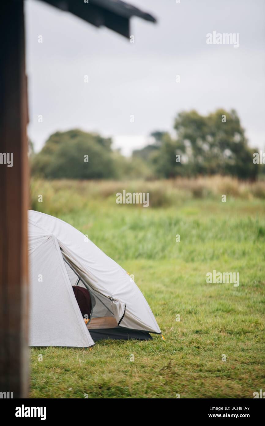 Camping Tent on Green Grass Meadow Stock Photo - Alamy