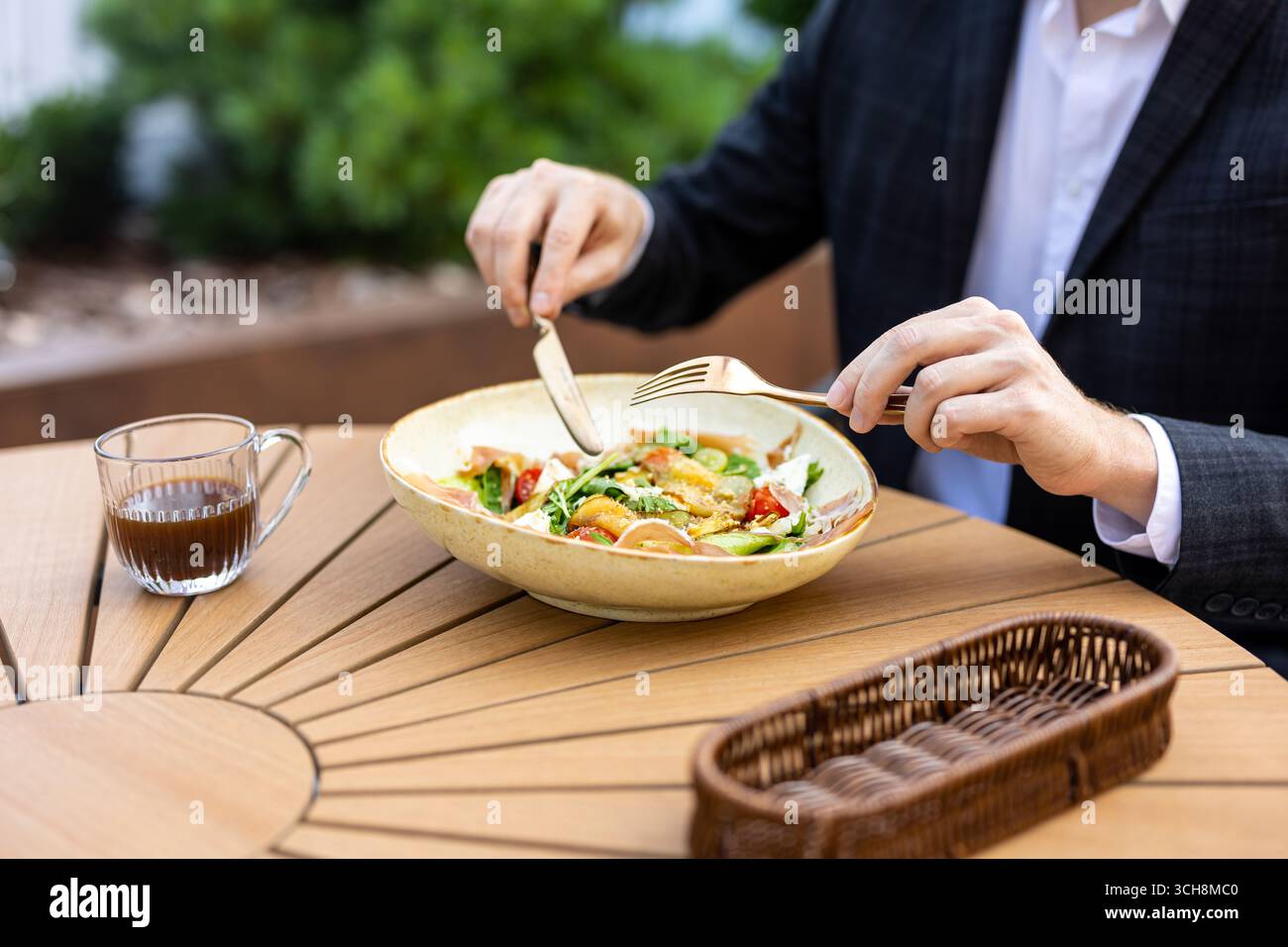 Unrecognizable professional in suit having lunch break Stock Photo