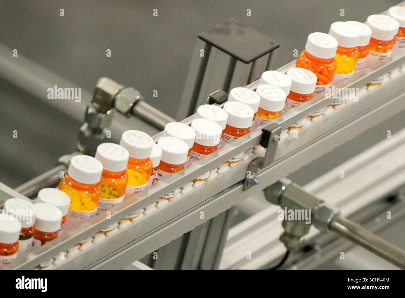 Drugstore Helicopter Ride FILE- Bottles of medicine ride on a belt at a mail-in pharmacy ...