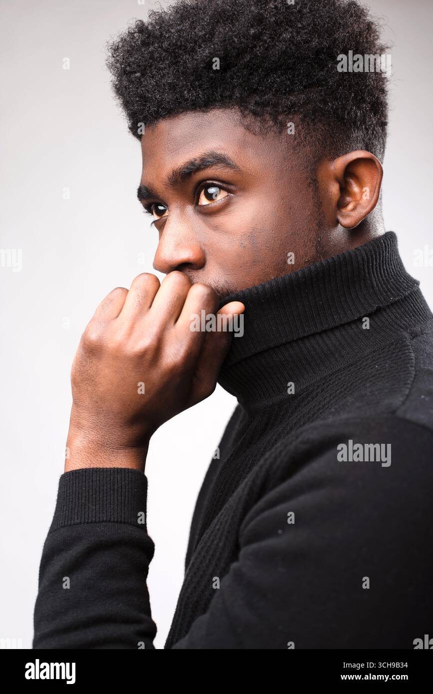 Handsome brunette man posing in black turtle neck sweater Stock Photo