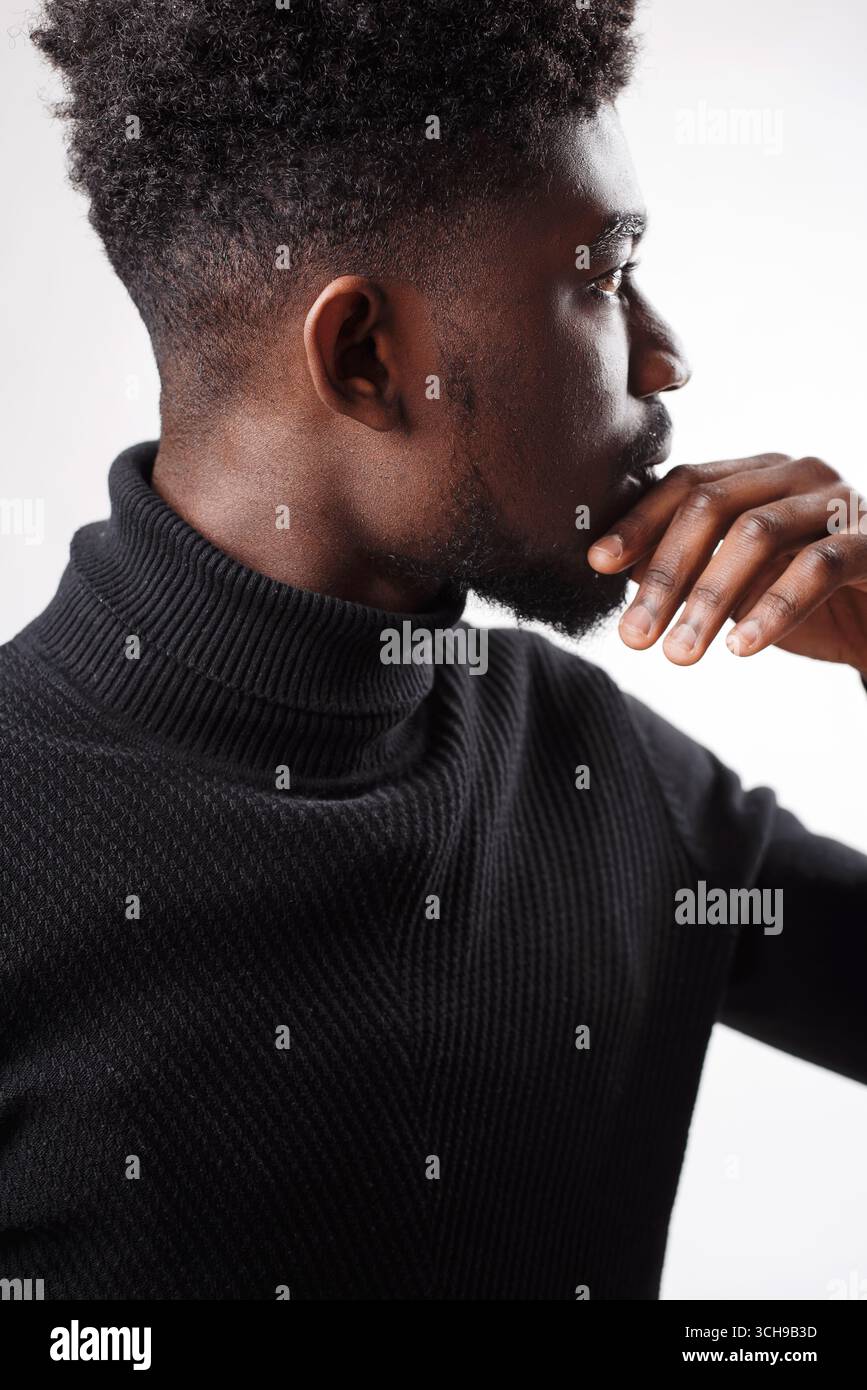 Serious authoritative bearded man standing looking away Stock Photo