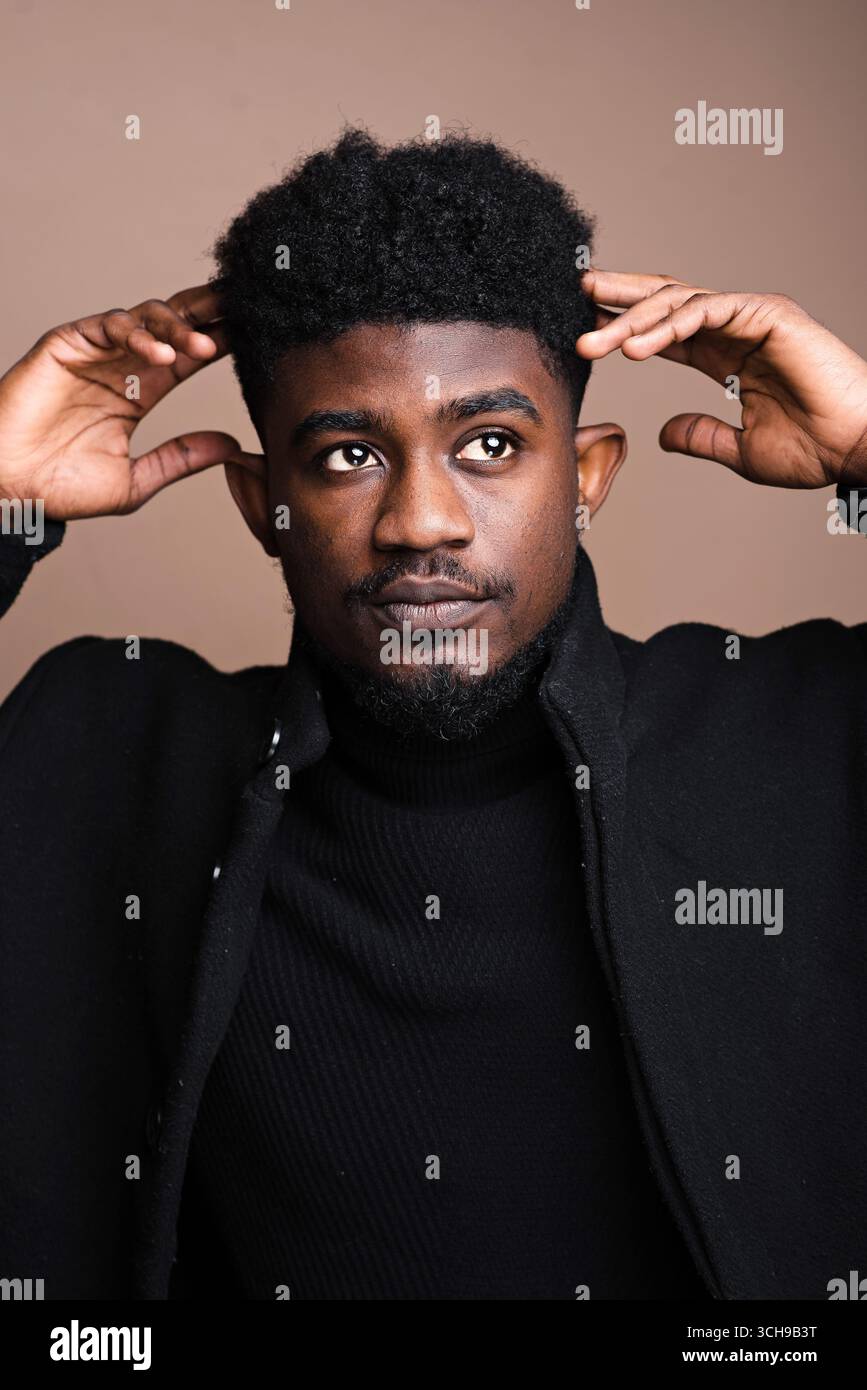 Young black male model posing hi-res stock photography and images - Alamy