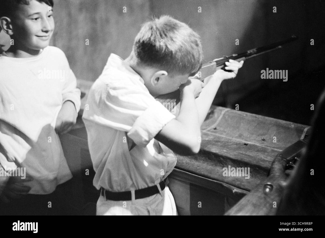 Boy shooting a rifle during carnival at firemens' convention, Sturgeon ...