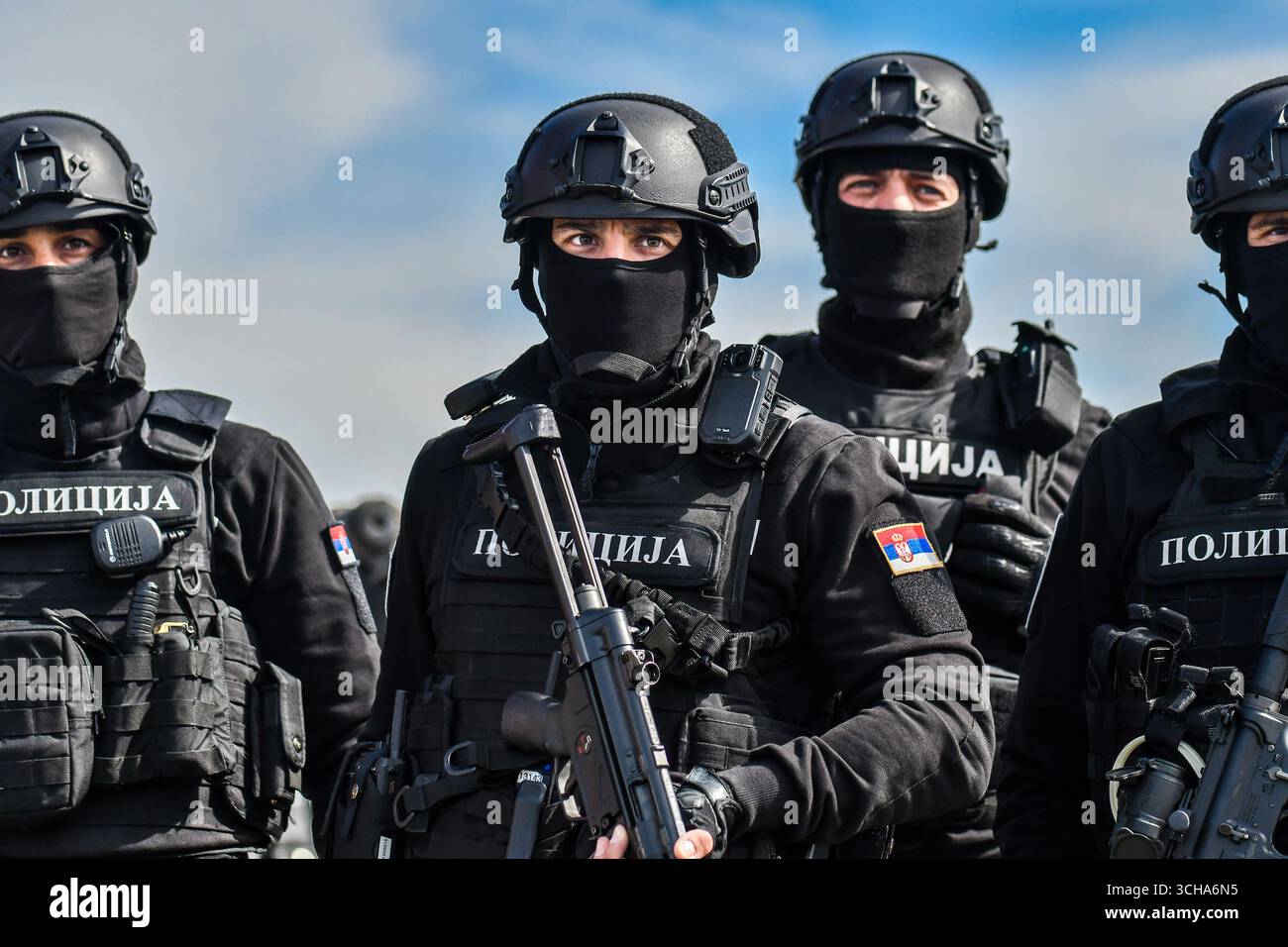 Four special police officers wearing balaclavas and uniforms, armed ...
