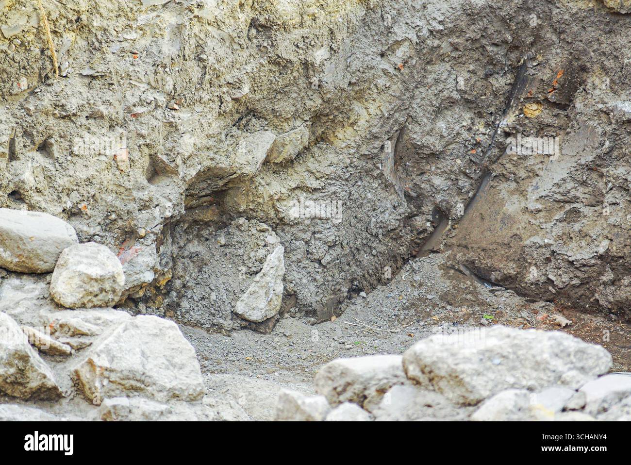 Natural limestone rocks and eroded soil formations displaying geological stratification and weathering processes. Environmental science Stock Photo