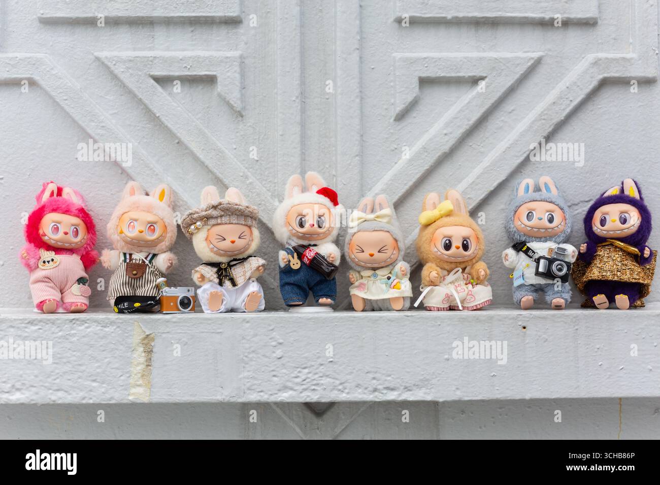 A group of eight Labubu posing for group shots while they are touring Singapore for sightseeing. Stock Photo
