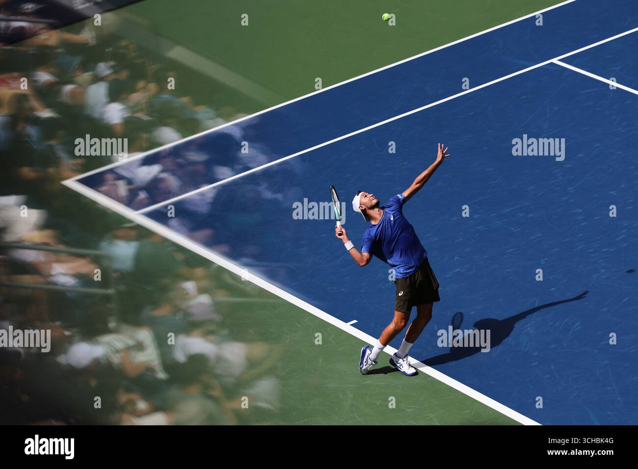 Leandro Riedi, of Switzerland, serves against Alex de Minaur, of ...
