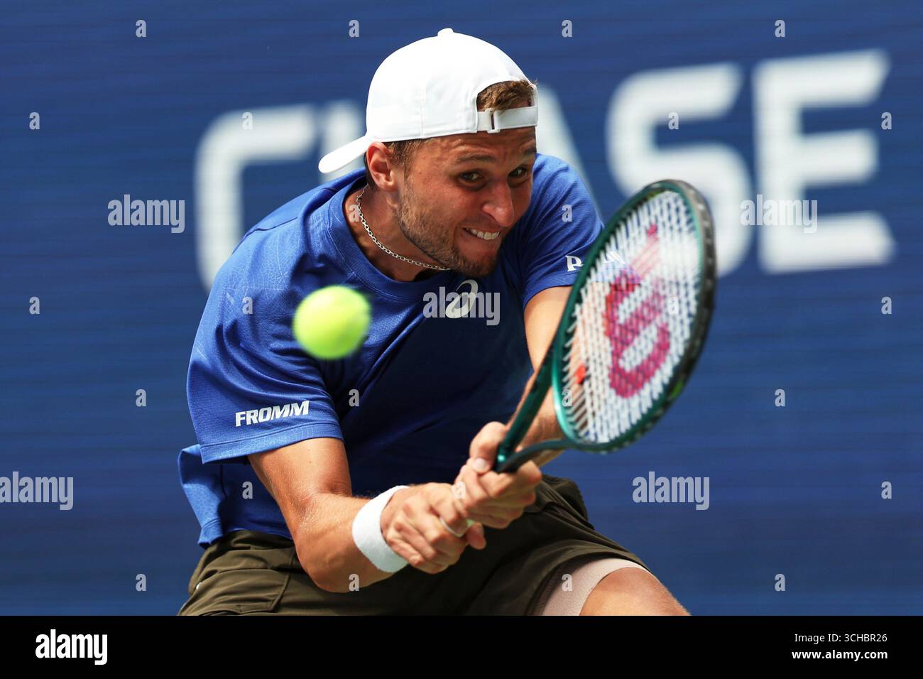 Leandro Riedi, of Switzerland, returns a shot against Alex de Minaur ...