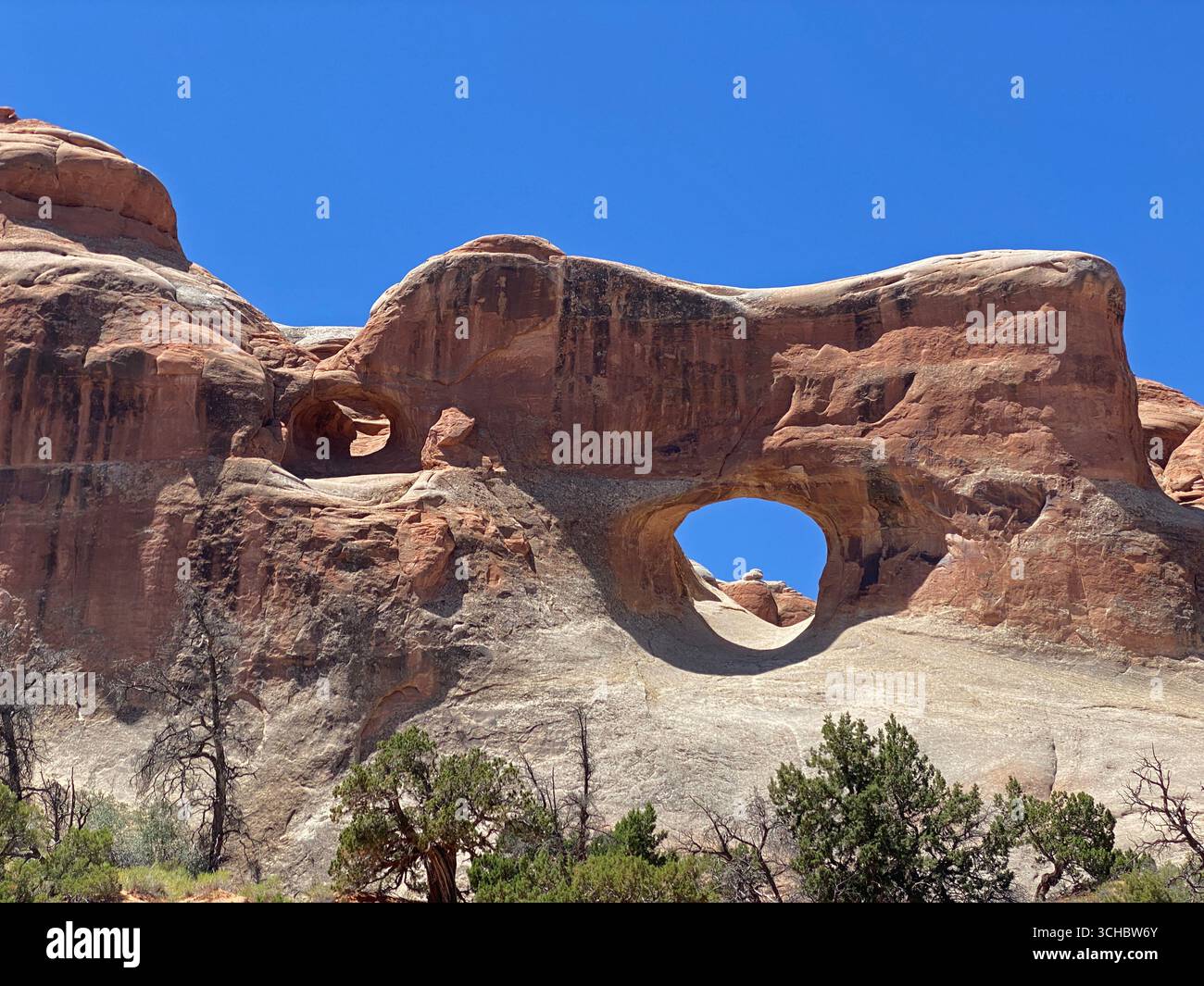 Two arches through large sandstone formations on Tunnel Arch Trail, in Arches National Park, Moab, Utah, USA - Smartphone Captured Stock Image