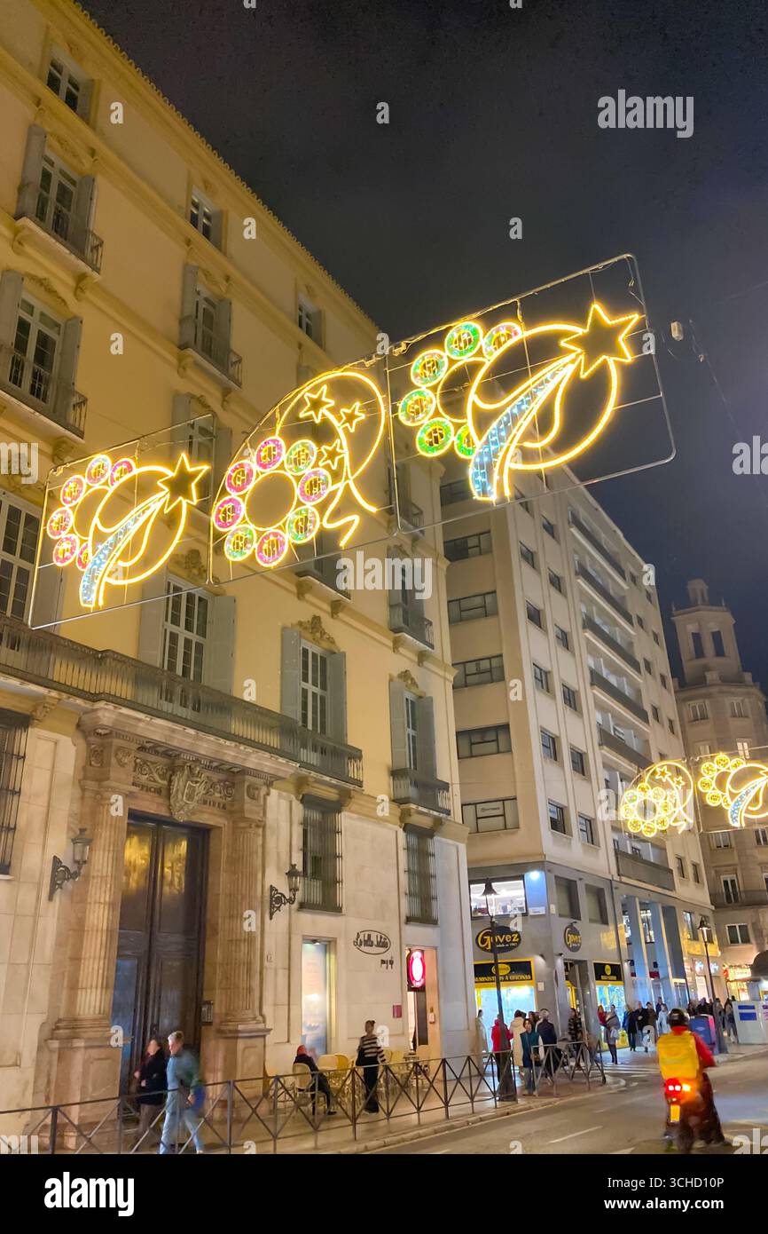 MALAGA, SPAIN - DECEMBER 21, 2024: The city center glows with enchanting Christmas decorations, creating a festive wonderland in Malaga, Spain - Smartphone Captured Stock Image