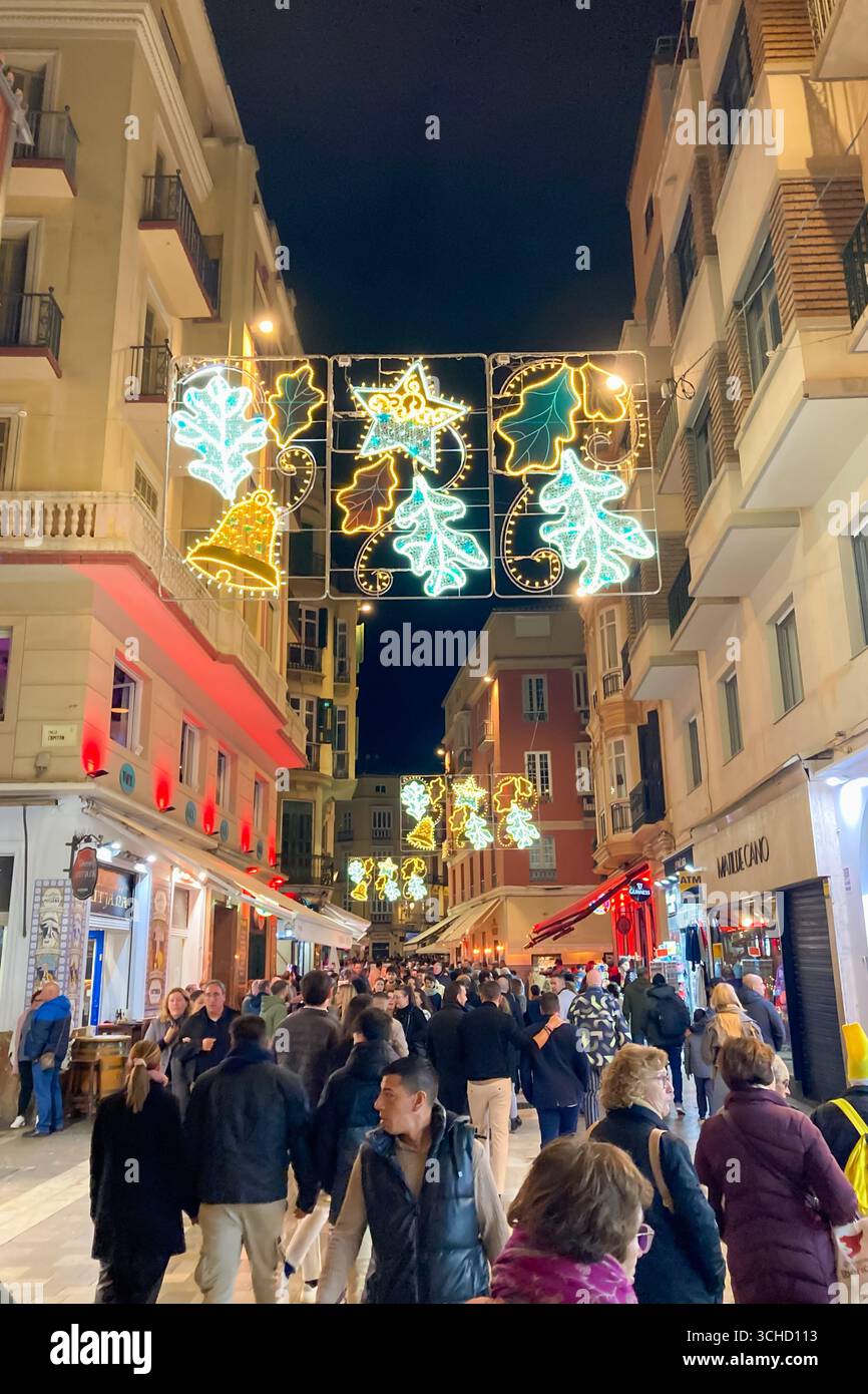 MALAGA, SPAIN - DECEMBER 21, 2024: The city center glows with enchanting Christmas decorations, creating a festive wonderland in Malaga, Spain - Smartphone Captured Stock Image