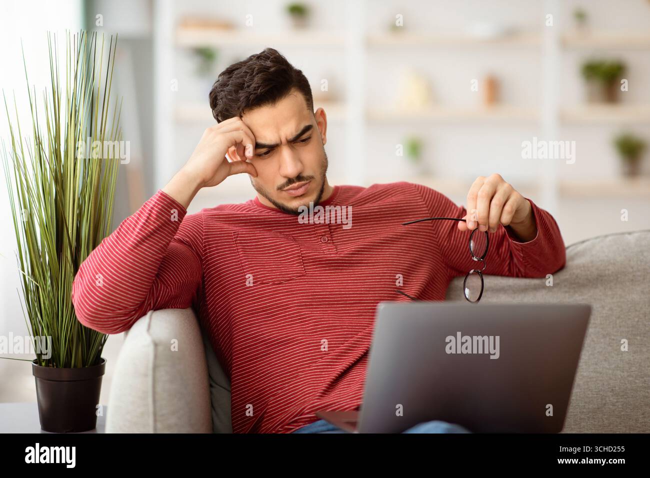 Pensive arab man working on laptop, looking for solution Stock Photo