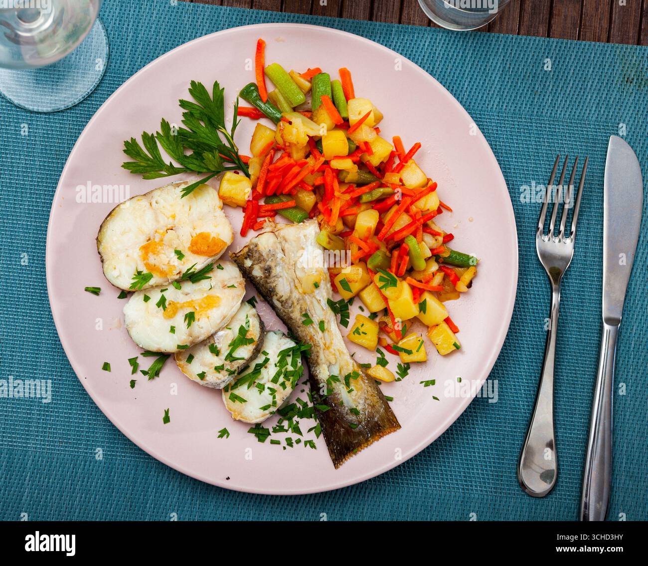 Oven baked hake with vegetable garnish Stock Photo