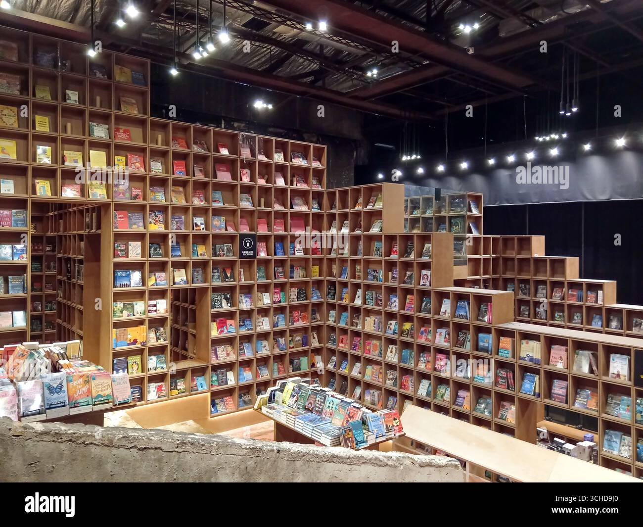 Cle Rex Bookstore Kuala Lumpur, Malaysia - March 3, 2025: Innovative wooden shelves fill ...