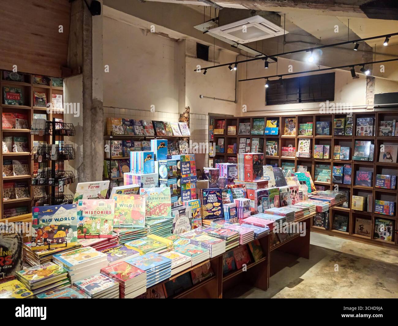 Cle Rex Bookstore Kuala Lumpur, Malaysia - March 3, 2025: Innovative wooden shelves fill ...