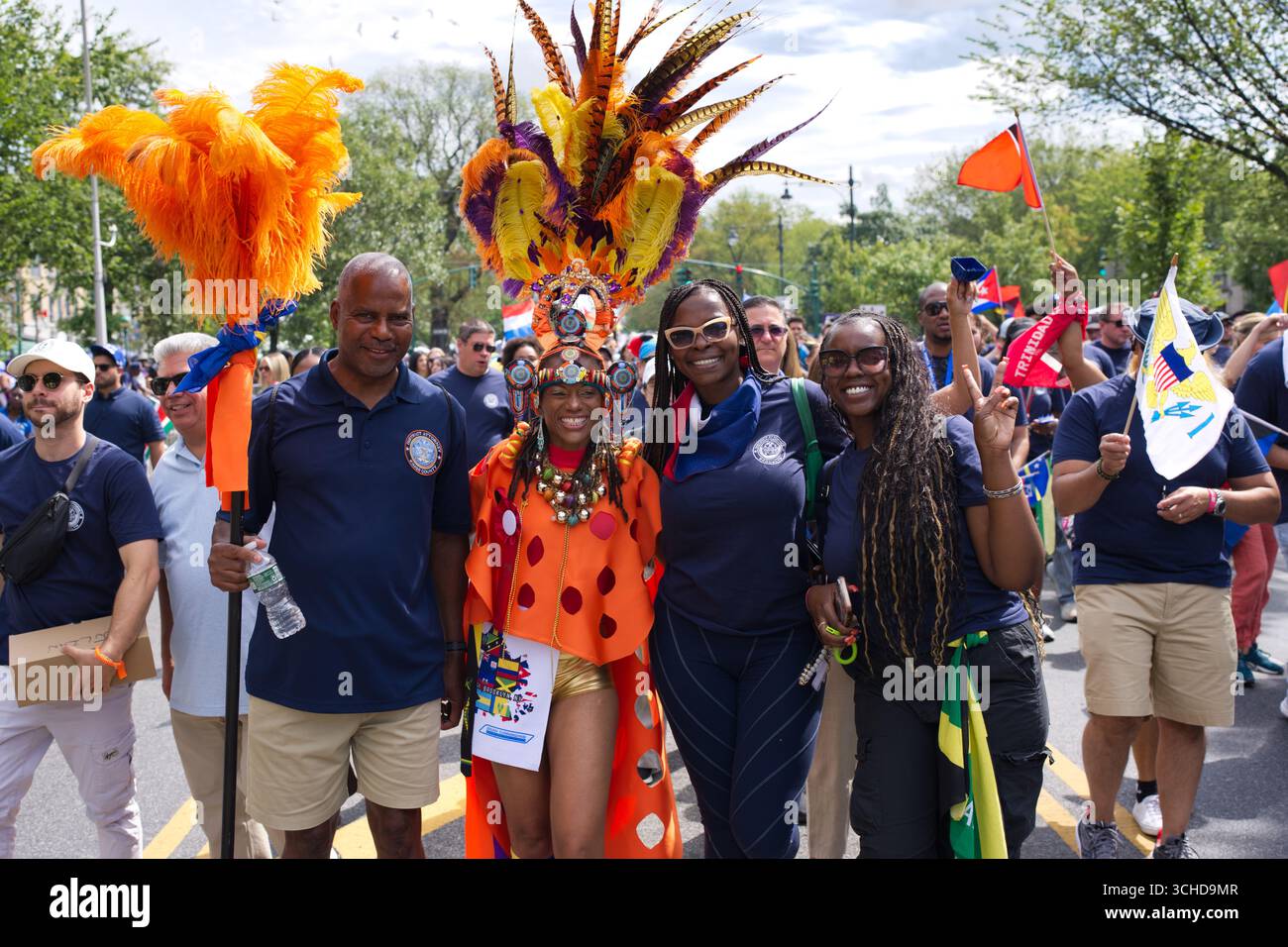 People in a parade, with one person in a colorful costume and headdress ...