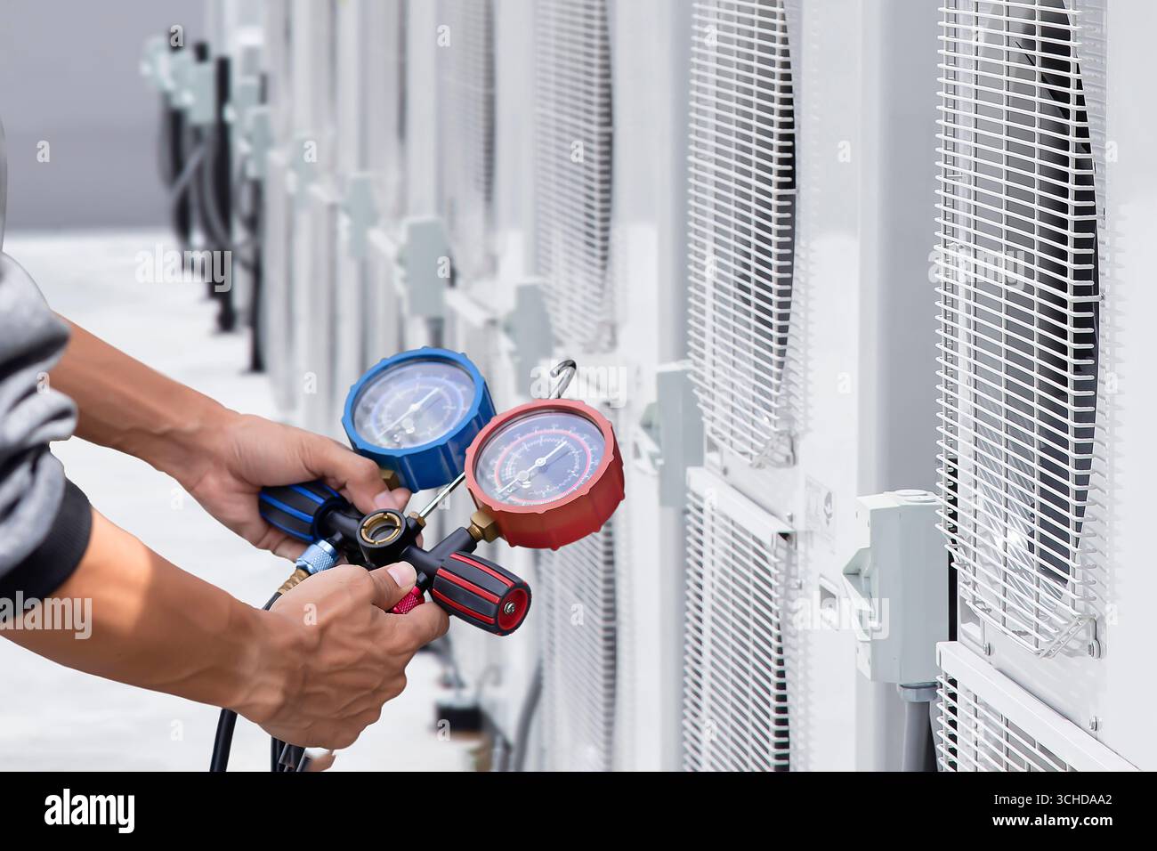 Technician checking air conditioning unit Stock Photo