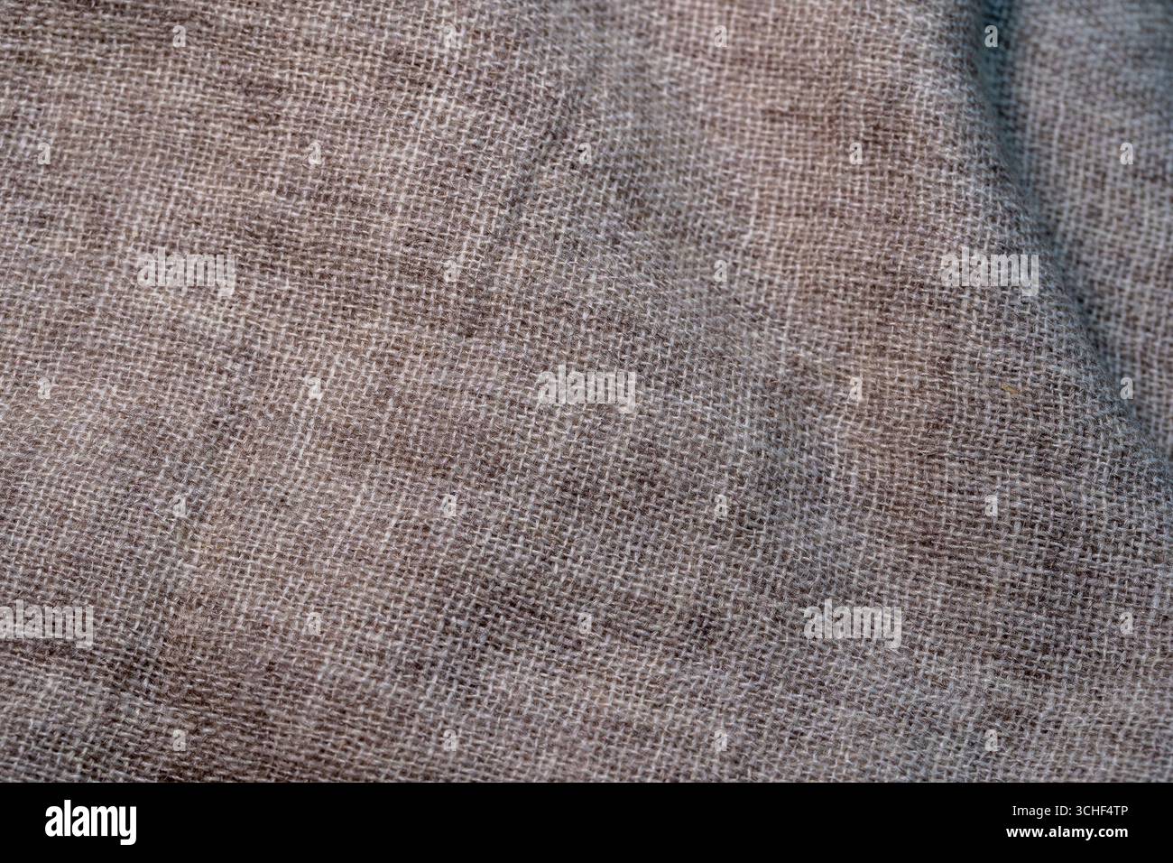 Crumpled textile texture as a background. Natural fabric linen texture for design. Close up Stock Photo