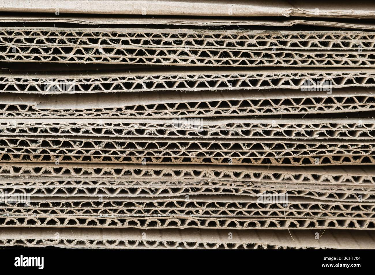 A stack of thick corrugated cardboard sheets close-up. Background Stock ...