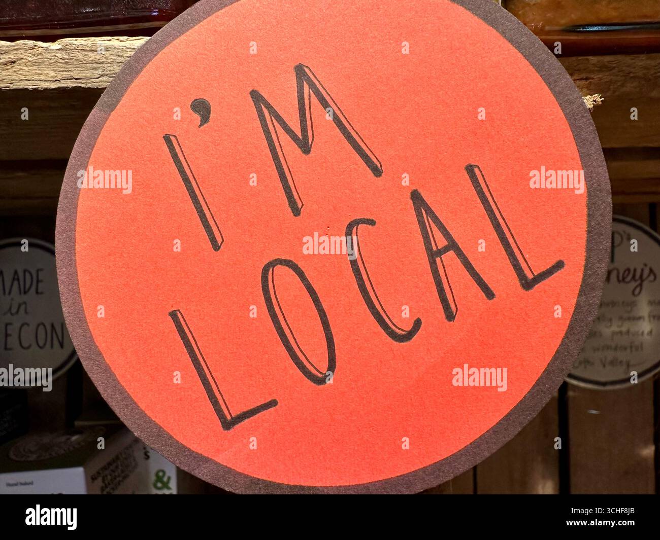 A sign in a local store claiming that the products sold are local: I'm Local - Smartphone Captured Stock Image
