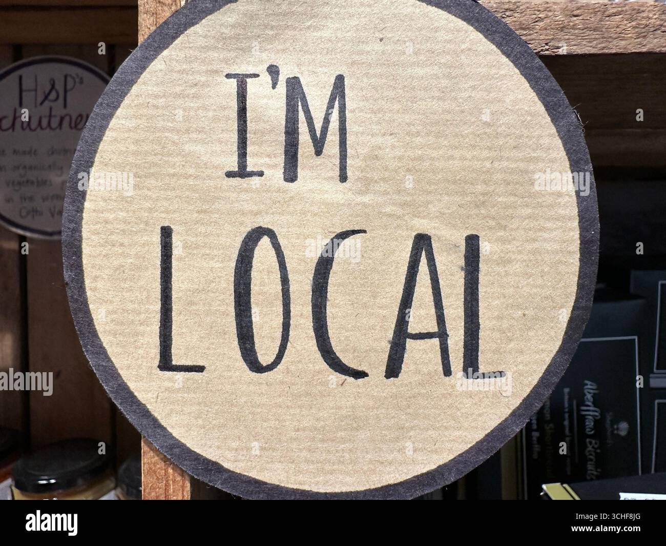 A sign in a local store claiming that the products sold are local: I'm Local - Smartphone Captured Stock Image
