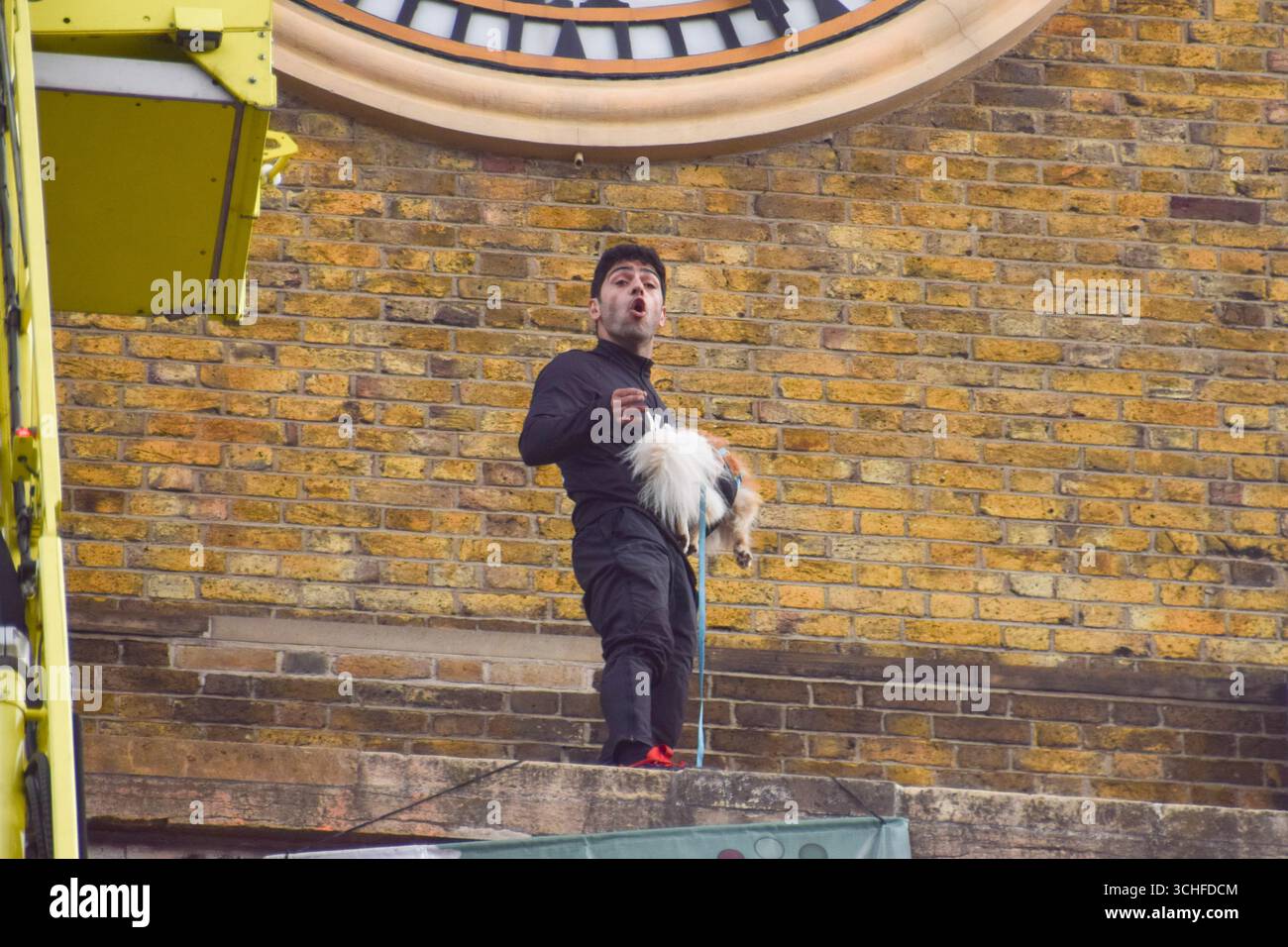 London, UK. 2nd September 2025. A protester stands next to the clock tower on top of King's Cross railway station with a dog. The man climbed on top of the station and unfurled a large 'Freedom For Iran' banner. Credit: Vuk Valcic/Ģ����ý Live News Stock Photo