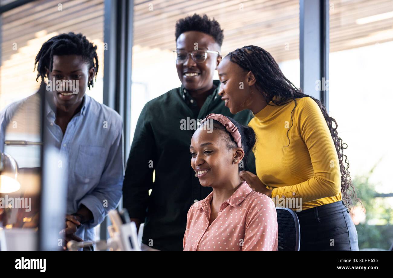 Collaborating in office, diverse team sharing ideas enthusiastically on project Stock Photo