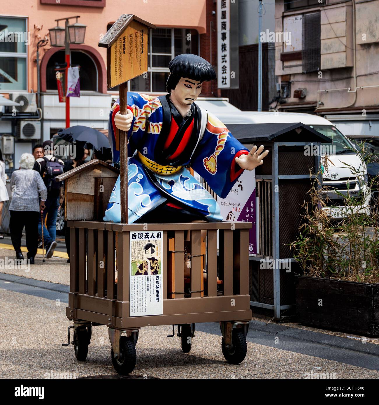 Restuarant decororation of a man dressed in a kimono sitting in a cart, in Japan, August 2025 - Stock Image