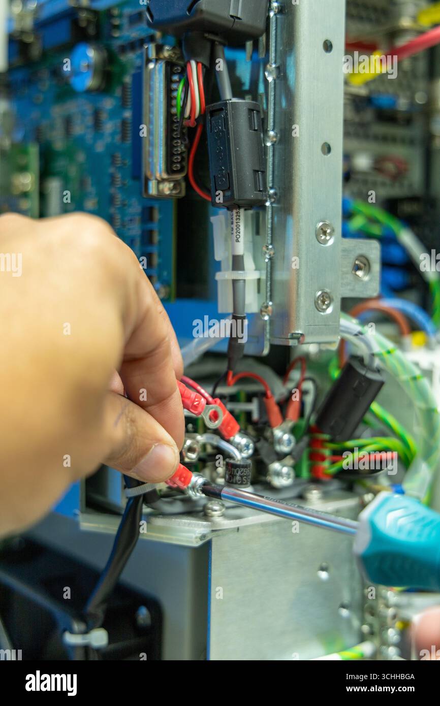 Man's hand repairing an electronic card Stock Photo - Alamy