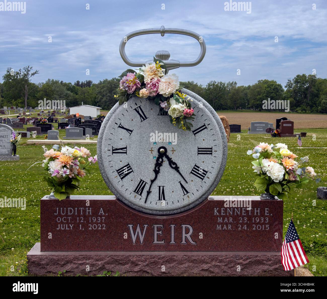 A unique gravestone in Greentown, Indiana, shaped like a pocket watch, marking time as a lasting tribute in stone. Stock Photo