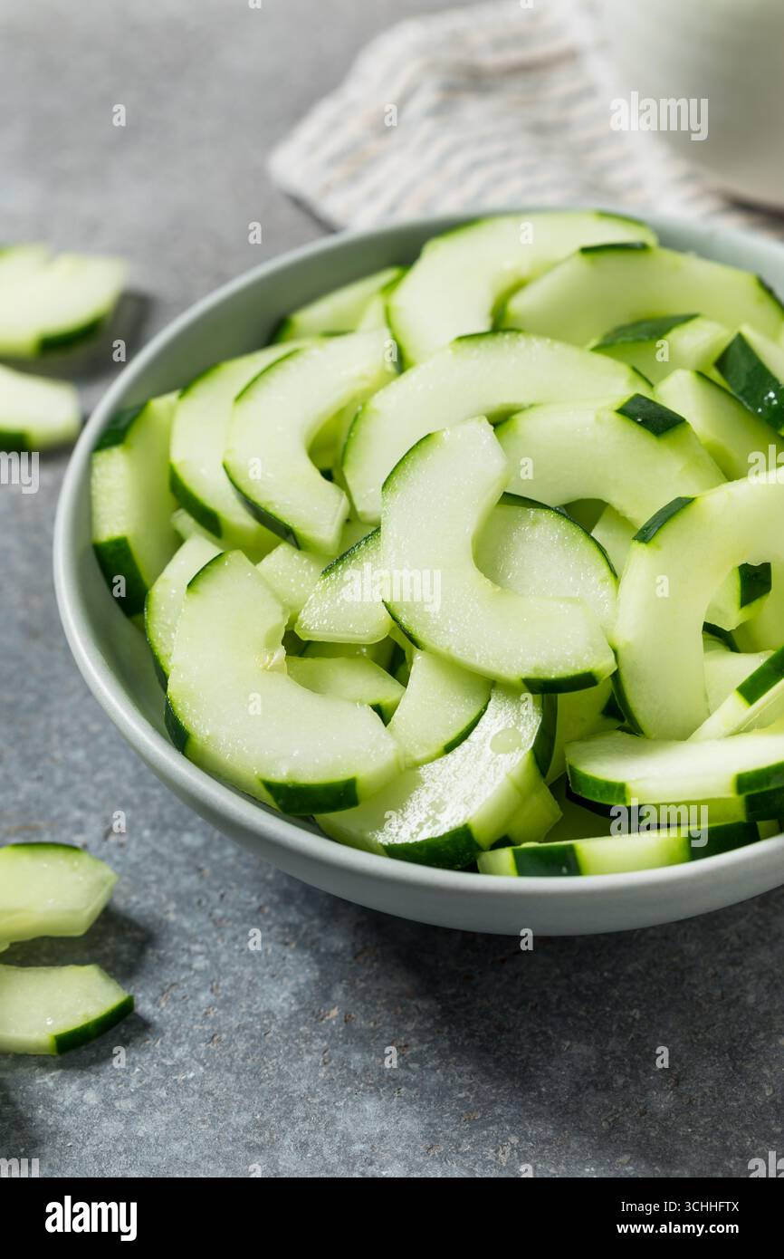 Raw Organic Cut Cucumber Slices in a Bowl Stock Photo