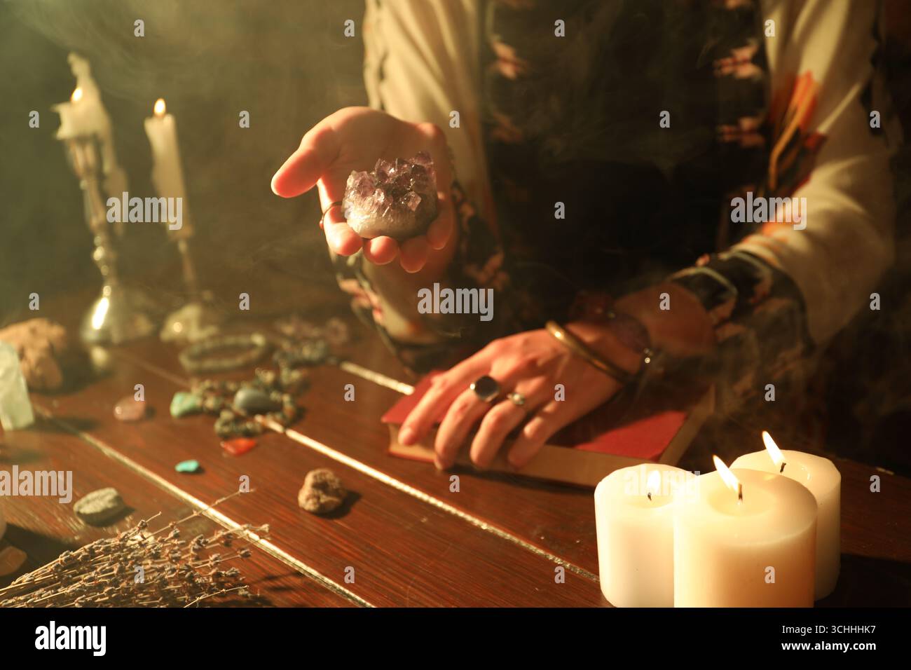 Woman doing ritual with healing stones at wooden table, closeup Stock ...