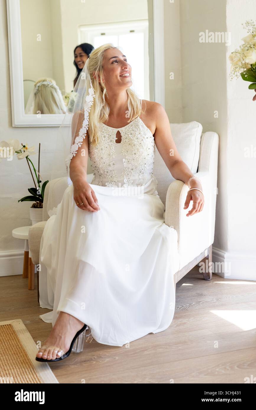 Bride sitting on chair hi-res stock photography and images - Alamy