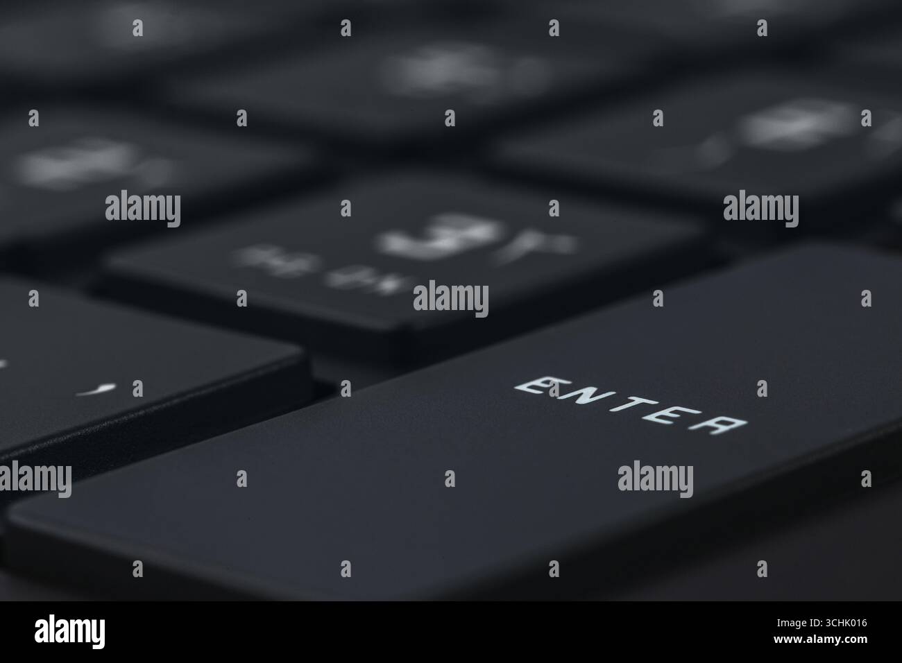 Close-up and full view of a modern computer keyboard, enter key Stock Photo