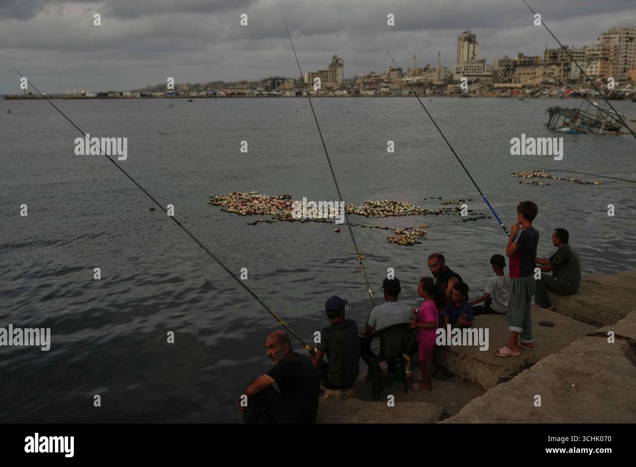 Palestinians fish at the seafront in the Gaza City port, Tuesday, Sept ...