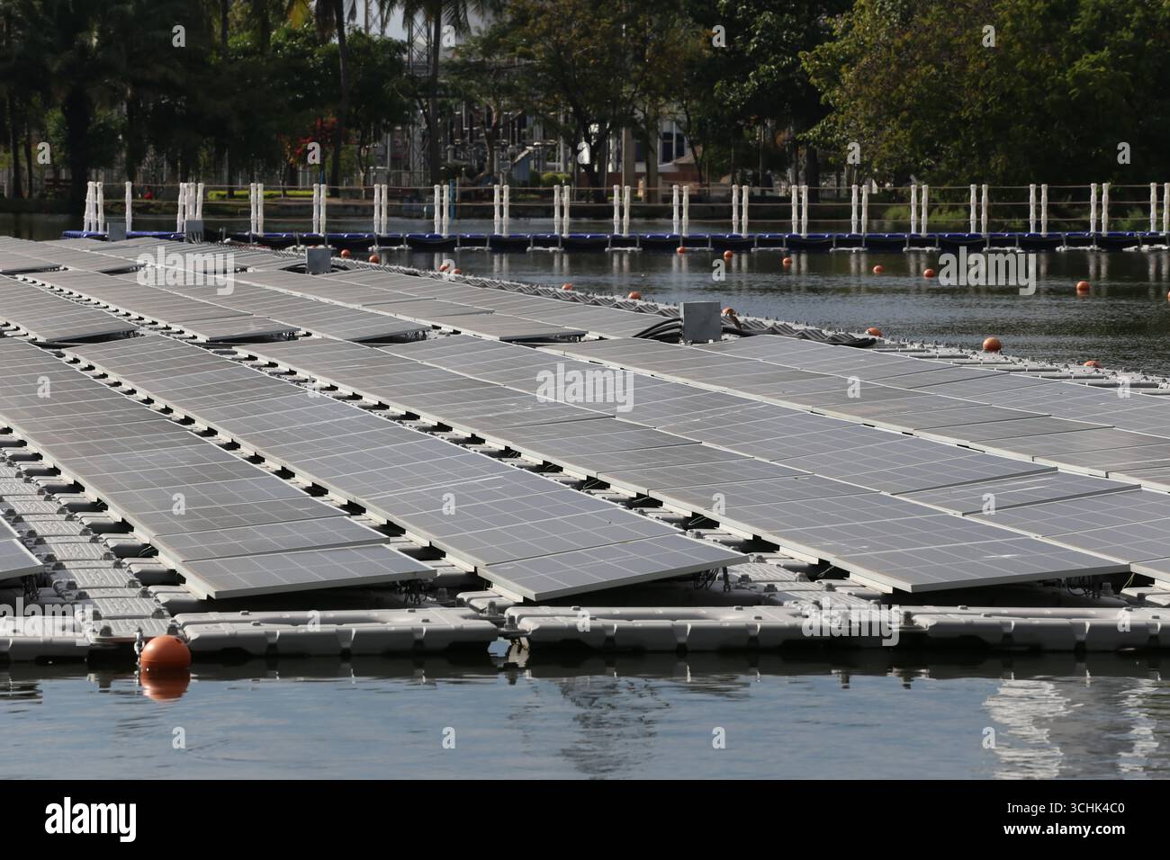 Floating solar panels set on a tranquil lake, demonstrating innovative ...