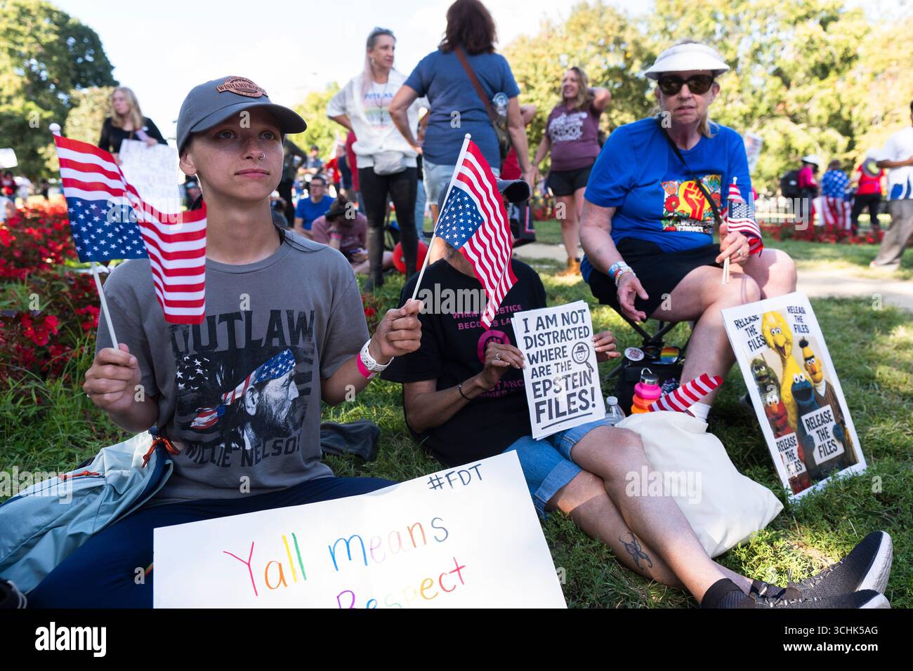 Katherine Distefano from Canton, Ga, left, holds American flags upside ...