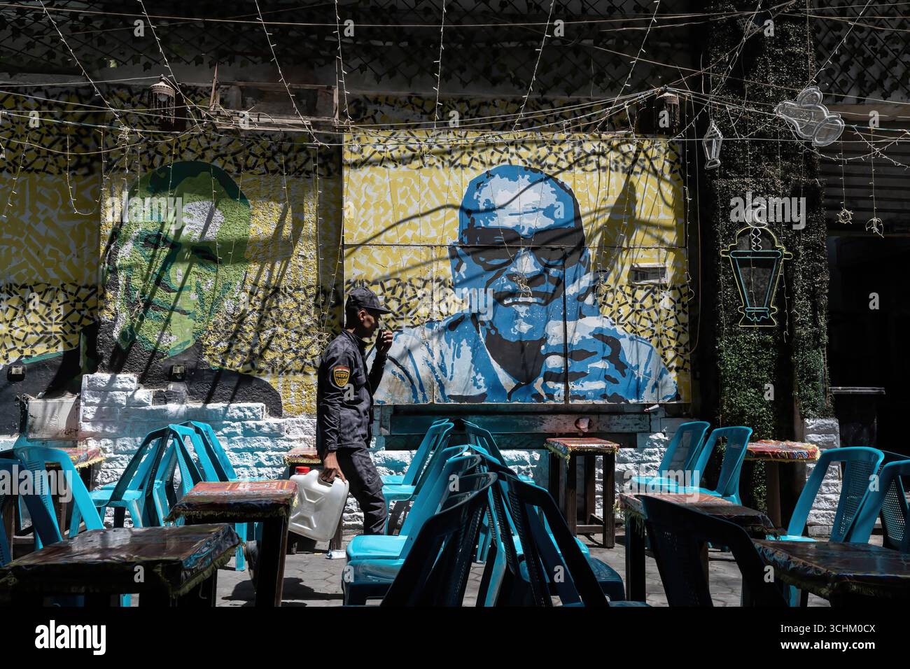April 18 2025 Cairo Egypt Empty Cafe Tables And A Street Art april-18-2025-cairo-egypt-empty-cafe-tables-and-a-street-art
