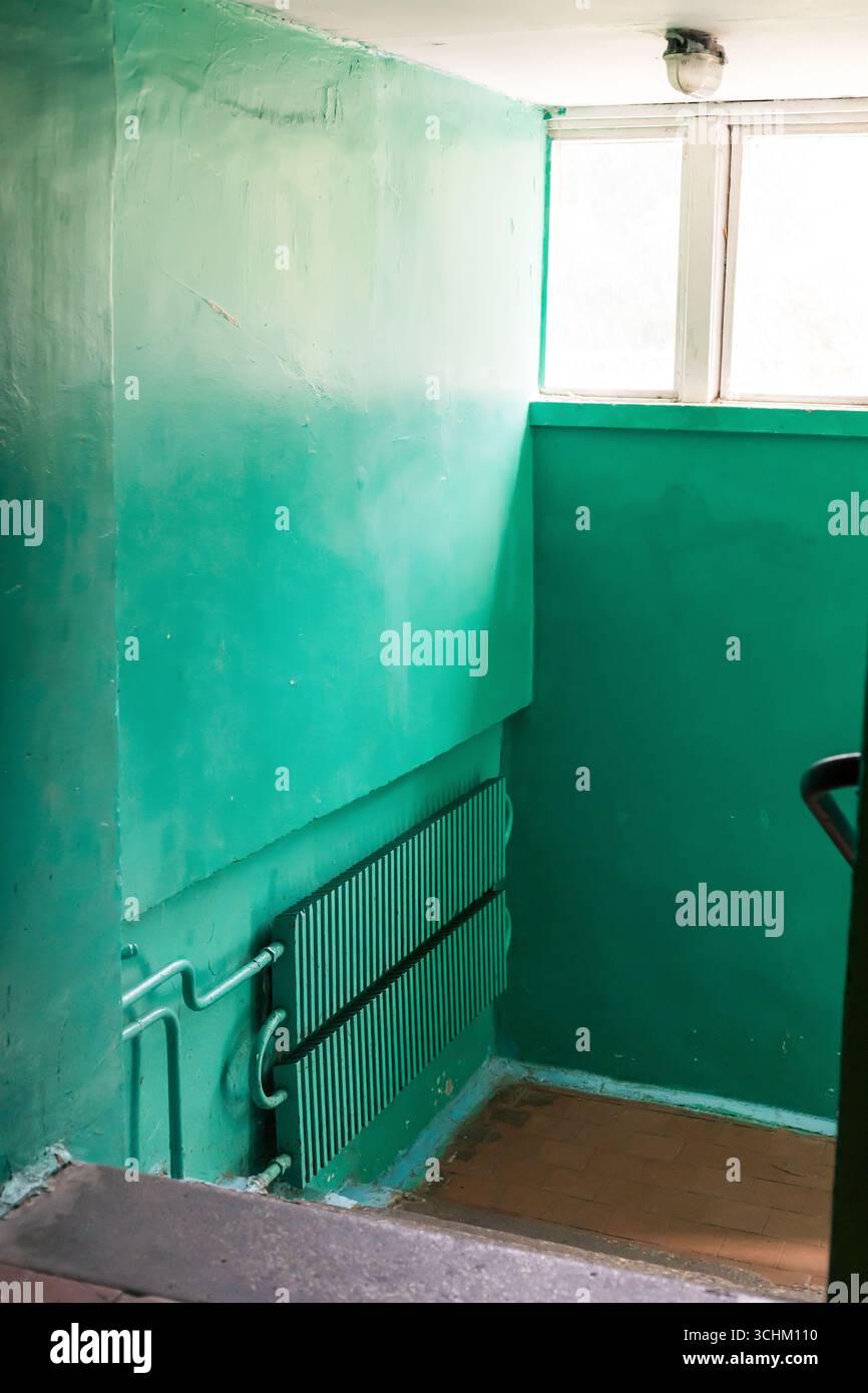 Interior of an old building in poor condition with green painted walls ...