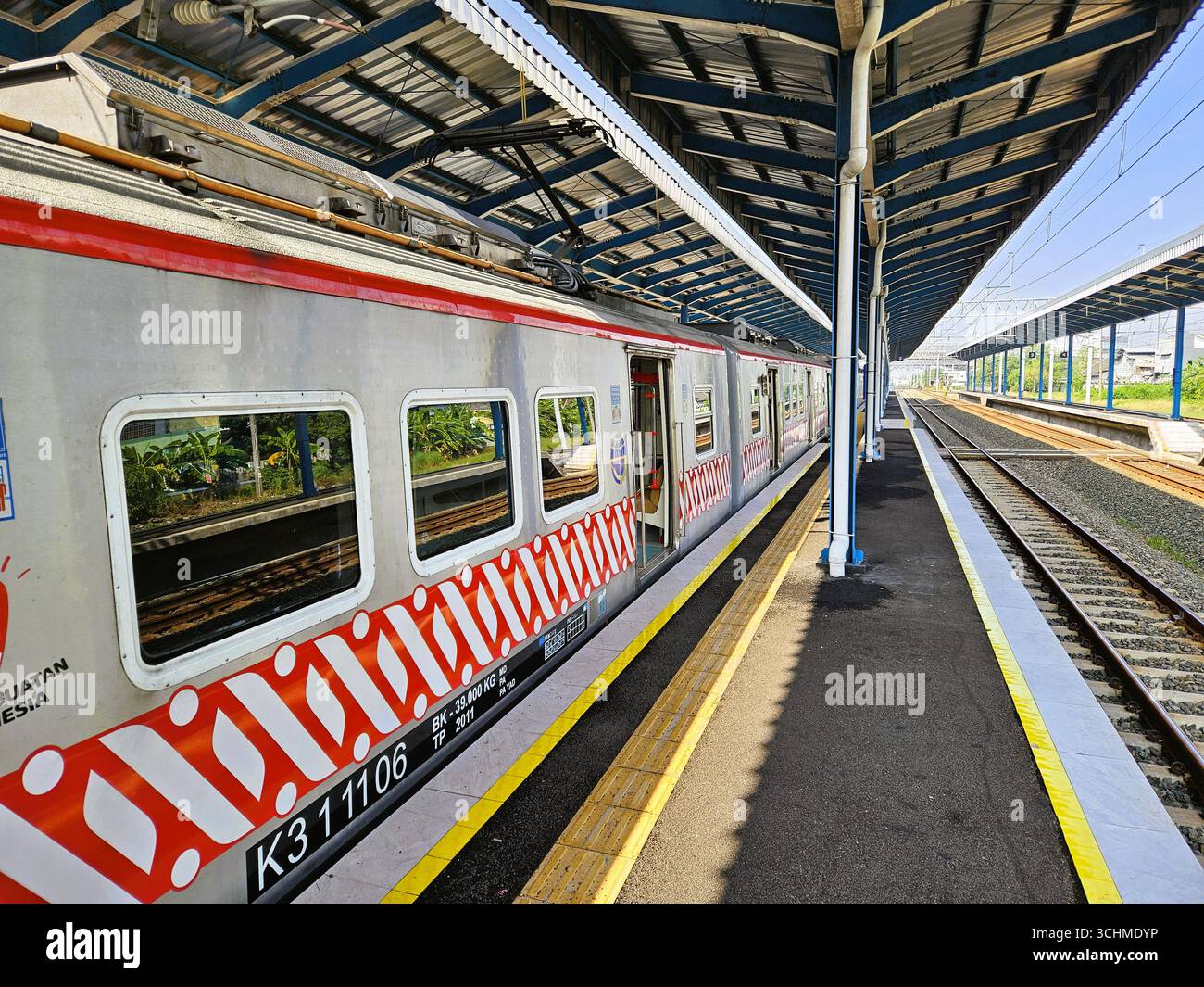 KRL (Electric Rail Train) Commuter Line waiting for passengers to depart from Palur Station. Solo, Indonesia - February 16th, 2024 - Smartphone Captured Stock Image