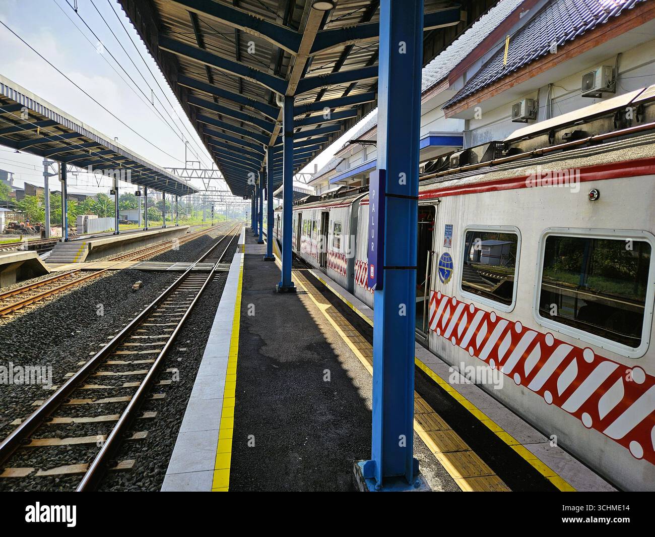 KRL (Electric Rail Train) Commuter Line waiting for passengers to depart from Palur Station. Solo, Indonesia - February 16th, 2024 - Smartphone Captured Stock Image