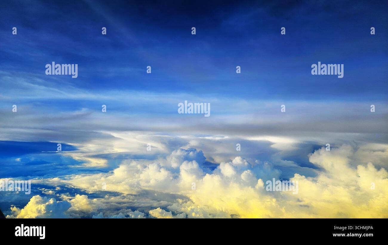 Beautiful aerial view of white clouds and deep blue sky, natural formation in bright daylight - Smartphone Captured Stock Image