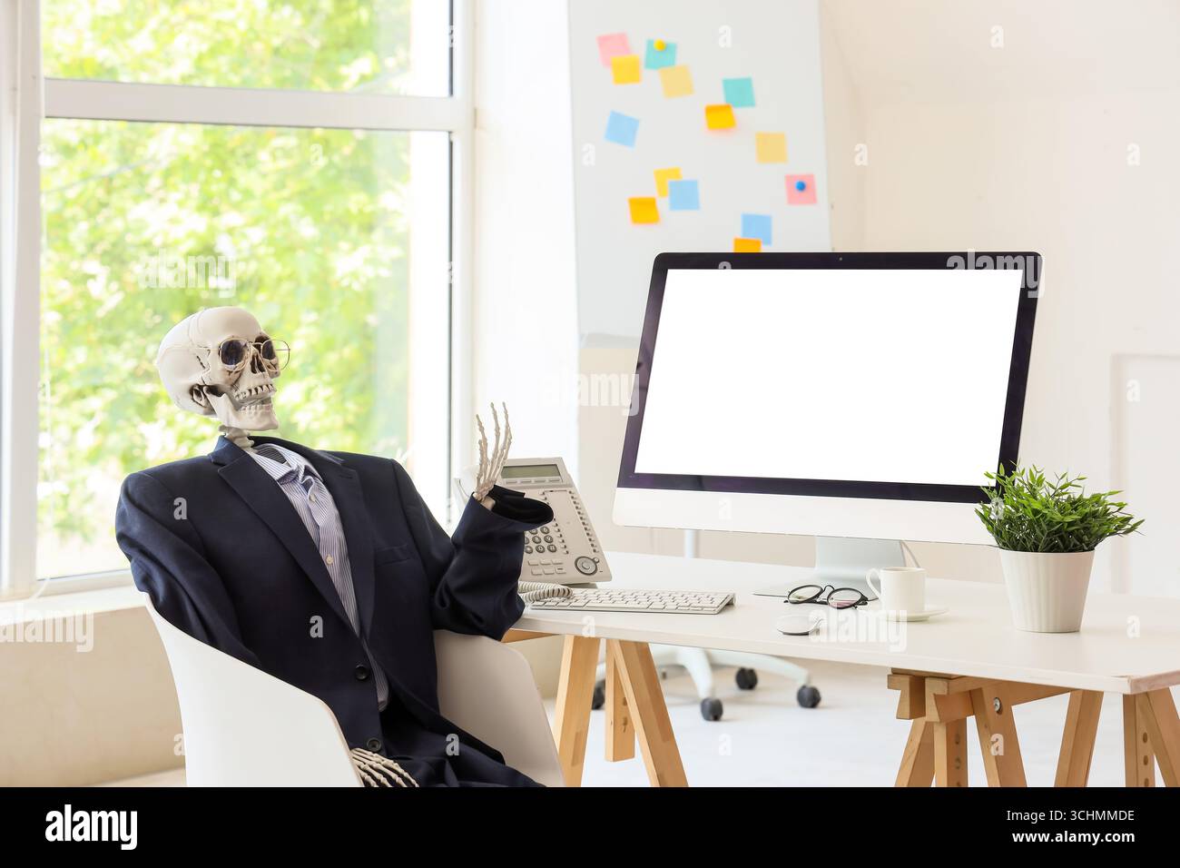 Human skeleton model at desk in office Stock Photo - Alamy