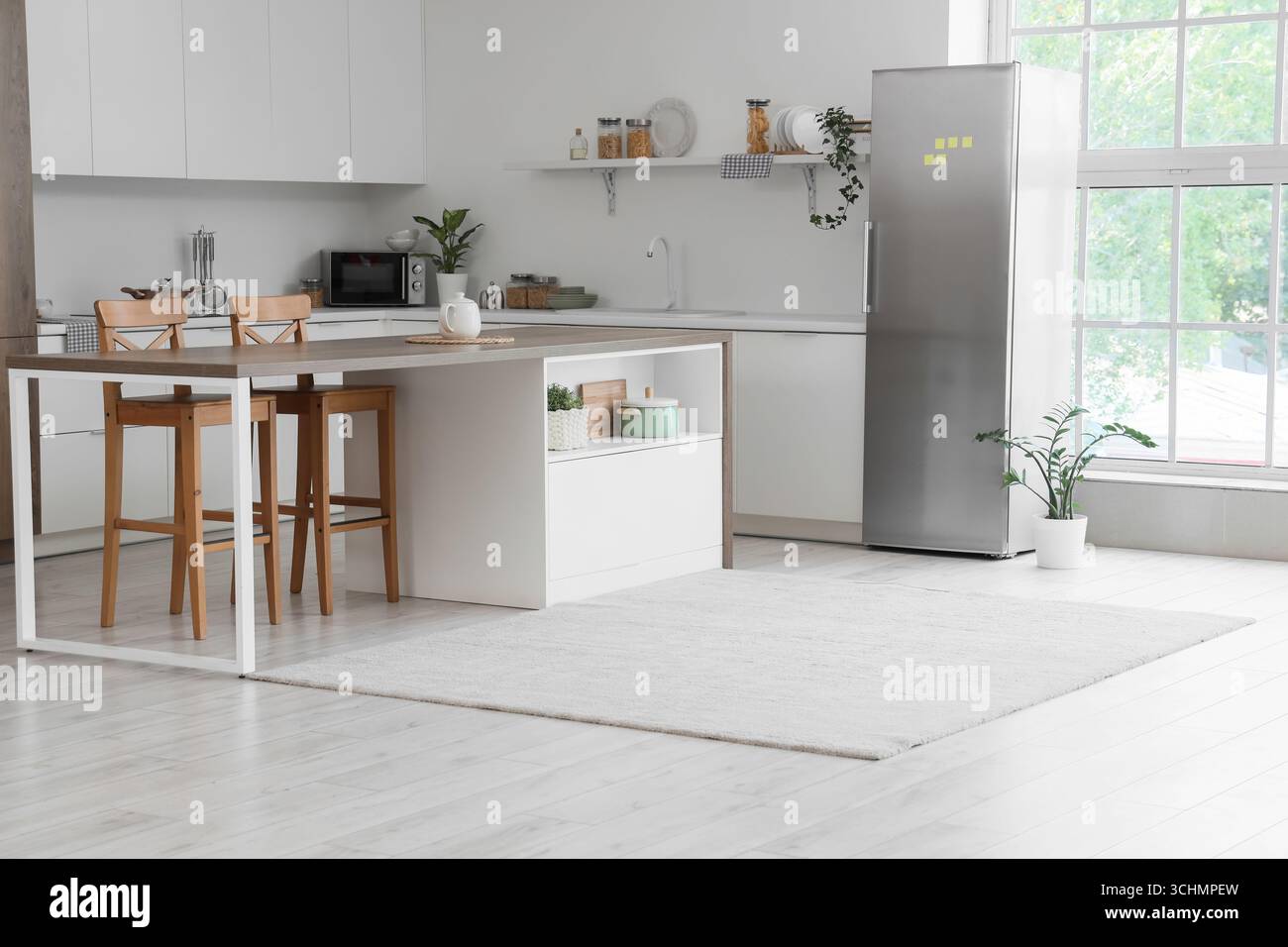 Interior of kitchen with modern fridge, counters and table Stock Photo ...