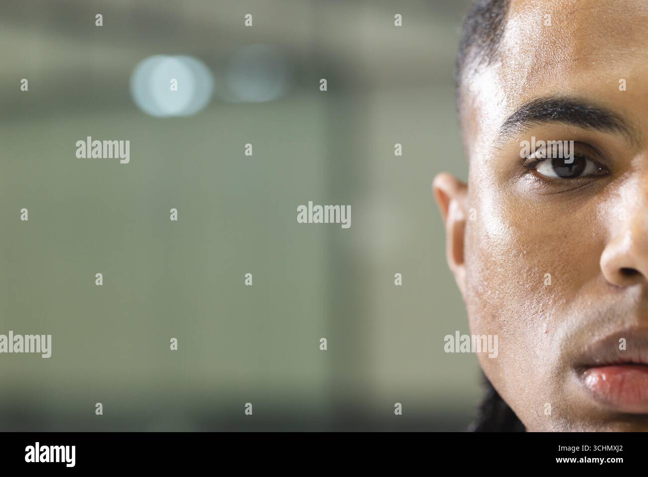 African american man leaning against wall panel while soft light reflecting, copy space Stock Photo