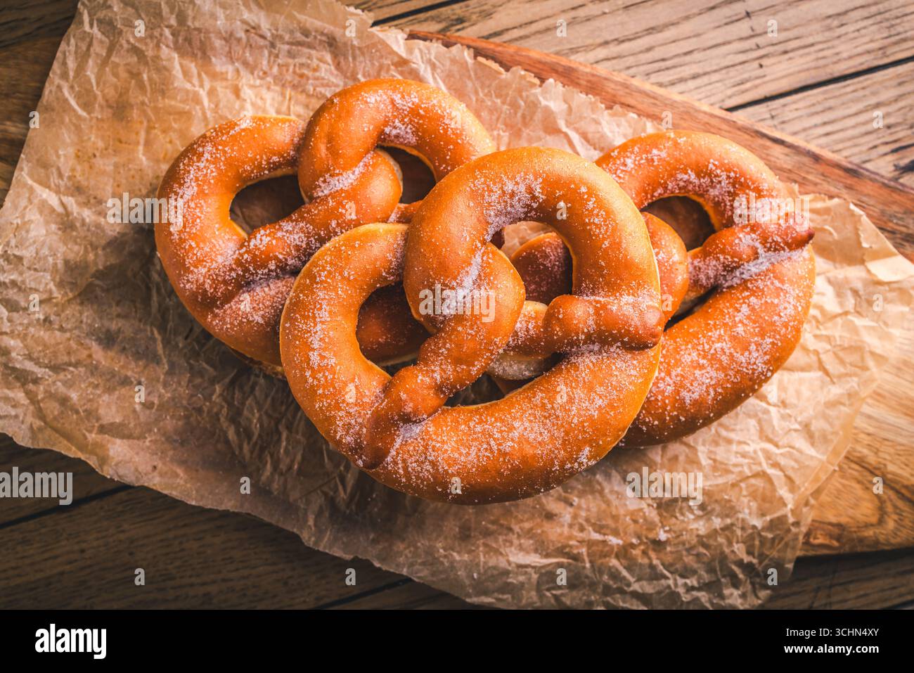 German sweet pretzels made from leavened dough, fusion of donut and pretzel, carnival food Stock Photo