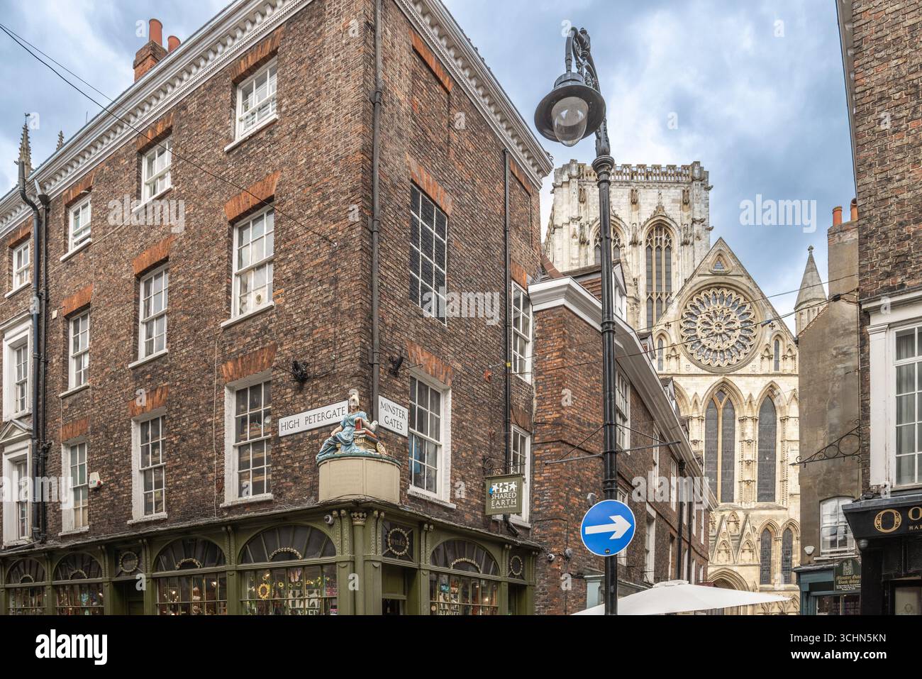 York Minster seen from High Petergate in York, England, with Gothic architecture, cathedral spires, and historic buildings along a narrow street. Stock Photo